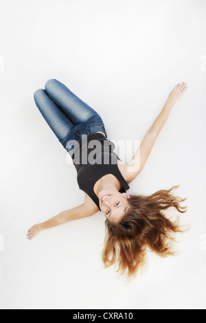 Young woman, lying on the floor Stock Photo