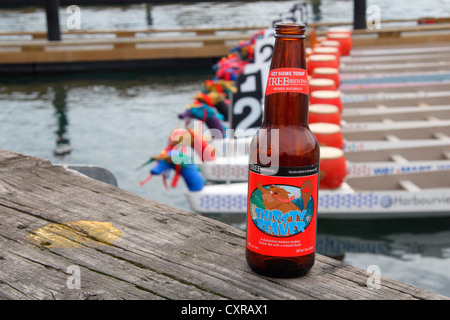 Bottle of beer and dragon boats in Victoria BC Stock Photo