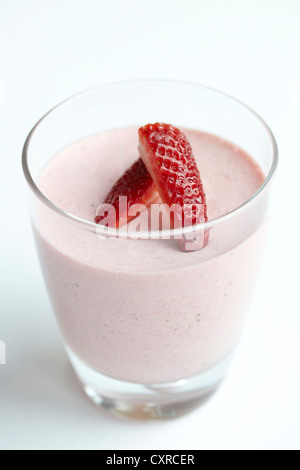 Strawberry mouse in a glass decorated with sliced strawberries Stock Photo