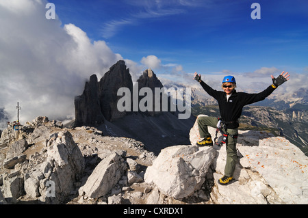 Teenager climbing on the Paternkofel fixed rope route, here standing on the summit of Paternkofel mountain Stock Photo