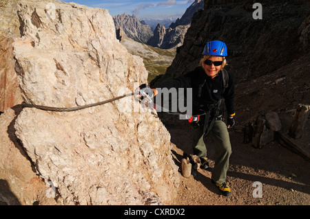 Teenager climbing on the Paternkofel fixed rope route, Hochpustertal valley, Dolomites, Province of Bolzano-Bozen, Italy, Europe Stock Photo