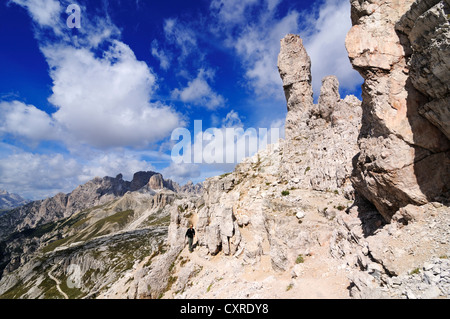 Teenager climbing on the Paternkofel fixed rope route past the Frankfurter Wuerstel rock, Salsiccia rock, Hochpustertal valley Stock Photo