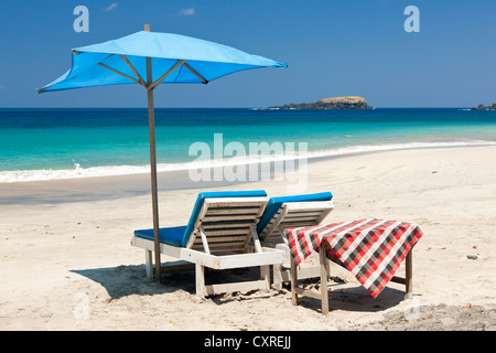 Sunloungers and a parasol at the beach, Pasir Putih or White Sand Beach, east of Candi Dasa, East Bali, Bali, Indonesia Stock Photo