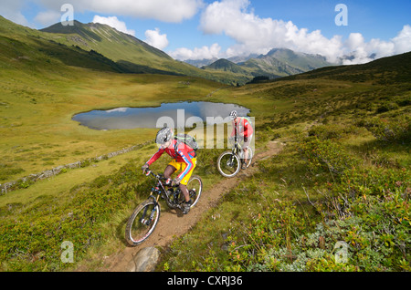 Mountain bikers on the Col des Anderets, lake Arnensee, Gstaad, Saanenland region, Bernese Oberland, Switzerland, Europe Stock Photo