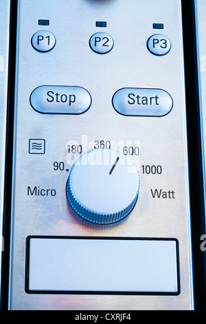 Close up of modern microwave control panel, blue light Stock Photo