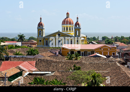 View from the tower of the Iglesia de la Merced church over the rooftops to the cathedral in front of Lake Nicaragua, Granada Stock Photo