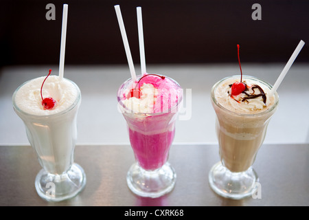 3 Milkshakes sit of a ice cream parlor counter. Stock Photo