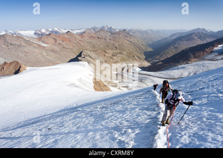 Hikers during the ascent to Similaun Mountain on Niederjochferner Glacier in Senales Valley, looking towards the Marzell ridge Stock Photo