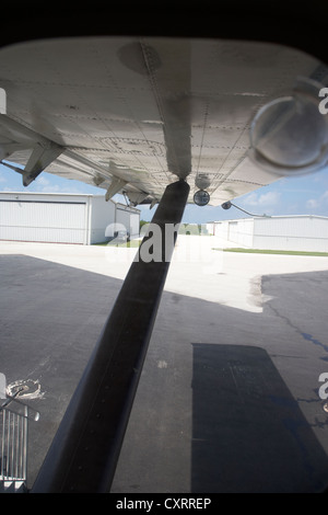 looking out through window at underside of wing of dehaviland dhc-3 otter seaplane at key west international airport florida key Stock Photo