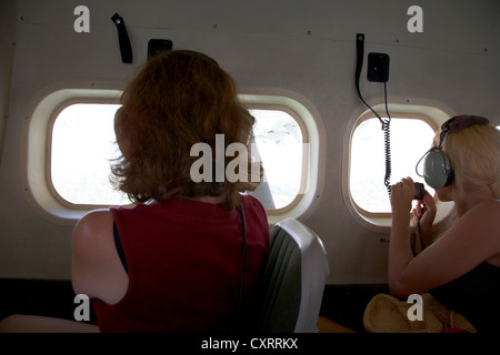 passengers looking out of window interior of dehaviland dhc-3 otter seaplane at key west florida keys usa Stock Photo