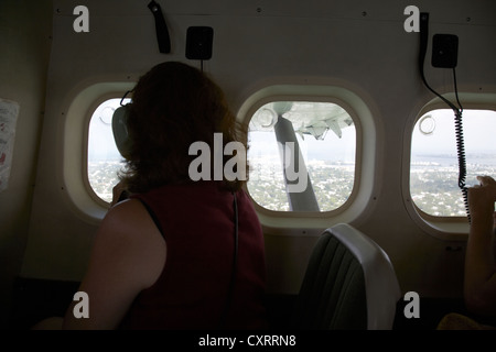 passenger looking out of window interior of dehaviland dhc-3 otter seaplane at key west florida keys usa Stock Photo