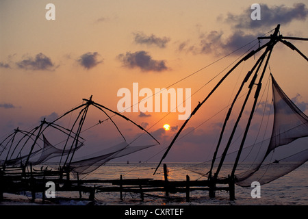 Typical Chinese fishing nets on the coast of the Arabian Sea at sunset in Fort Kochi, Cochin, Kerala, South India, India, Asia Stock Photo