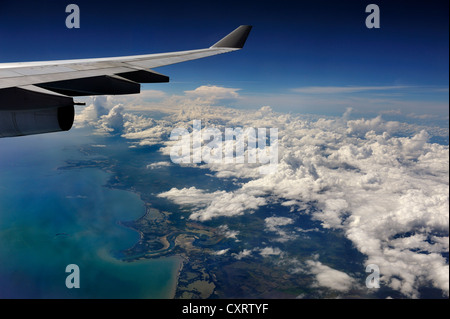 View from an aircraft, clouds and the ocean from above, wing of an airplane, Cuba, Caribbean Stock Photo