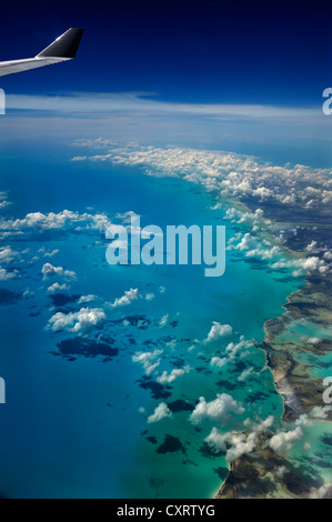 View from an aircraft, clouds, ocean and the wing of an airplane, Cuba, Caribbean Stock Photo