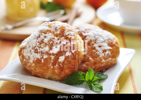 Two buns with apple stuffing on plate with mint closeup. Small shallow dof. Stock Photo