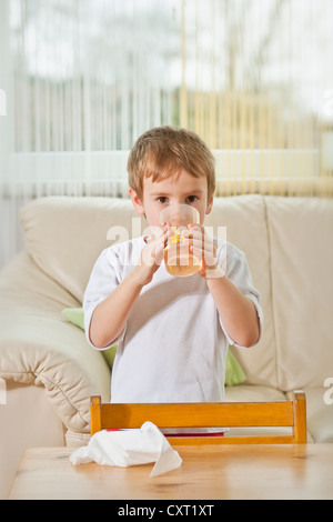 Boy drinking in the living room Stock Photo