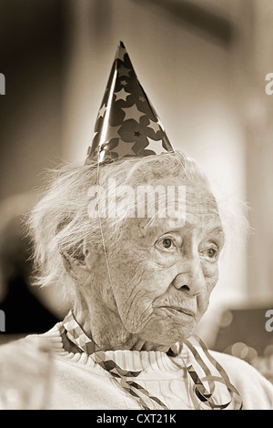 Old woman wearing a party hat, portrait Stock Photo