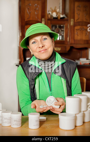 Woman holding Schuessler salts, complementary medicine Stock Photo