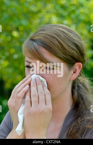 Woman blowing her nose, handkerchief, hanky Stock Photo