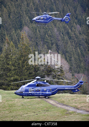A EC 135 T2i helicopter, at the top, and a AS 332 L1 Super Puma, at the bottom, of the German federal police, Mangfall Mountains Stock Photo