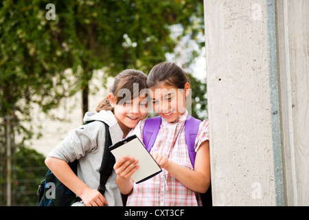 Two girls communicating with a tablet PC Stock Photo