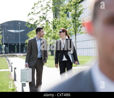 Colleagues chatting on their way to work Stock Photo