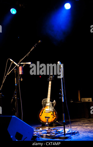 Guitar on stage with spotlights Stock Photo