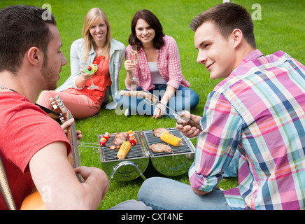 Group of young people at a barbecue in the garden Stock Photo