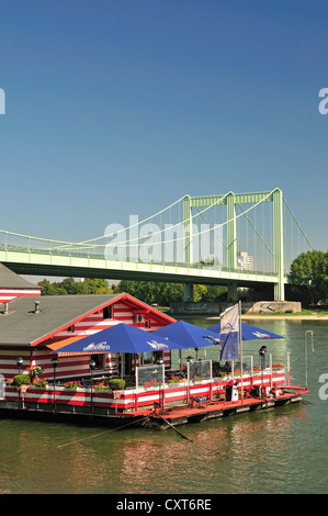 Alte Liebe boat house, a restaurant on a boat on the River Rhine near Cologne-Rodenkirchen, the Rodenkirchen highway bridge at Stock Photo