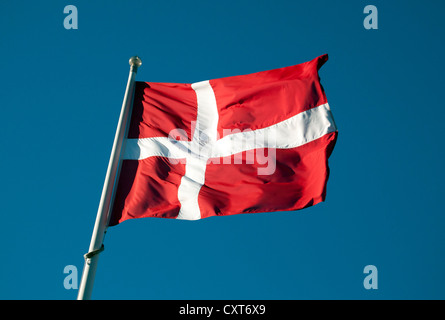 Danish flag flying against a dark blue sky Stock Photo