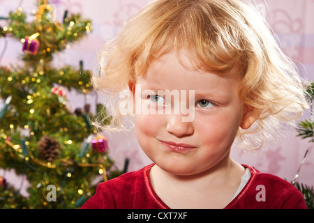 Girl, 4, portrait, with a thoughtful expression at Christmas Stock Photo