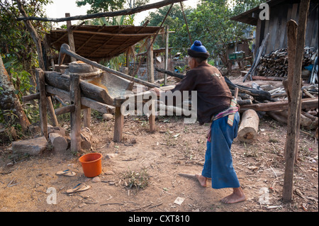 Husband working on a corn mill, village of hill tribe people, Hmong people, northern Thailand, Thailand, Asia Stock Photo