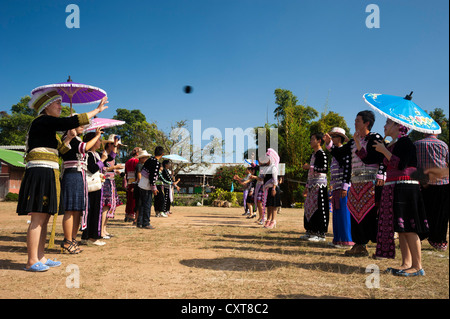 Young people in traditional dress, playing ball, New Year festival, Hmong hill tribe, ethnic minority, Chiang Mai province Stock Photo