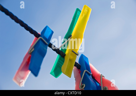 Close up of plastic clothes pegs peg on washing line England UK United Kingdom GB Great Britain Stock Photo