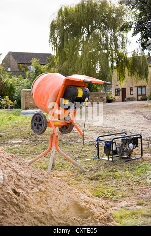Electric Cement Mixer on a building site powered by a Generator Stock Photo