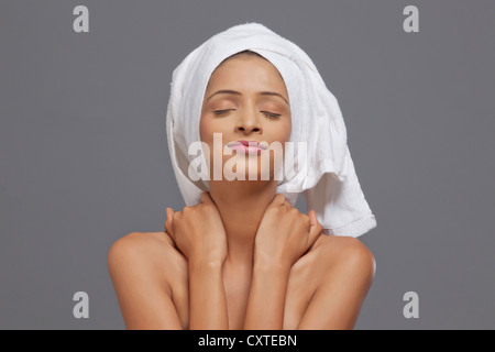 Woman smiling with a towel on head Stock Photo