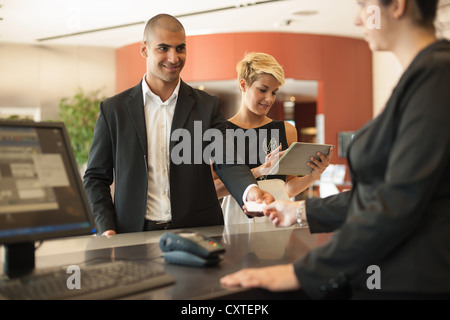 Businessman checking into hotel Stock Photo