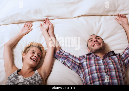 Couple relaxing on hotel room bed Stock Photo