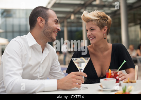 Smiling couple having drinks outdoors Stock Photo