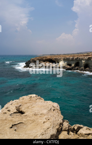 dh  CAPE GREKO CYPRUS Tourists sea caves near Cape Greco Ayia Napa area rocky south coast Stock Photo