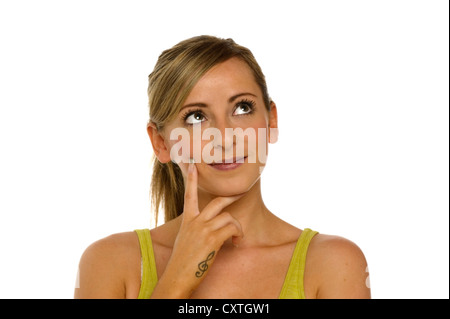 Young Woman looking up thinking isolated on a white background Stock Photo