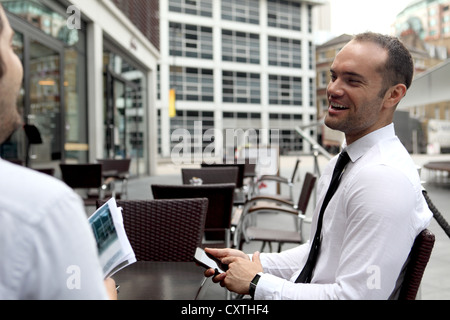 Businessmen talking at cafe Stock Photo