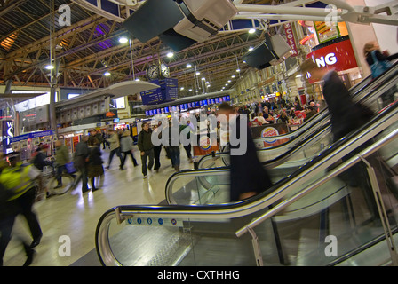 Horizontal interior wide angle of Waterloo railway station's concourse during the busy evening rush hour. Stock Photo