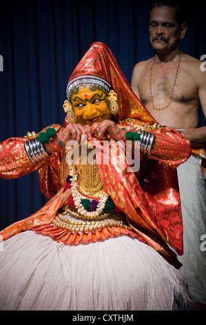 Vertical close up portrait of a male Kathakali performance artist playing the part of the female character Minukku. Stock Photo