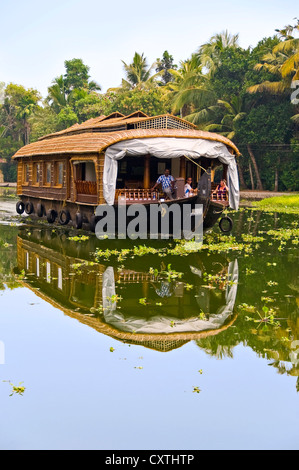 Vertical view of a traditional wooden house boat, kettuvallam, sailing through the backwaters of Kerala. Stock Photo