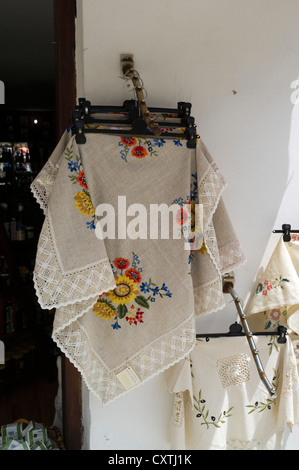 dh  TROODOS CYPRUS Cyprus lace craftwork displayed for sale souvenir shop lacework hand made cloth handmade shops Stock Photo