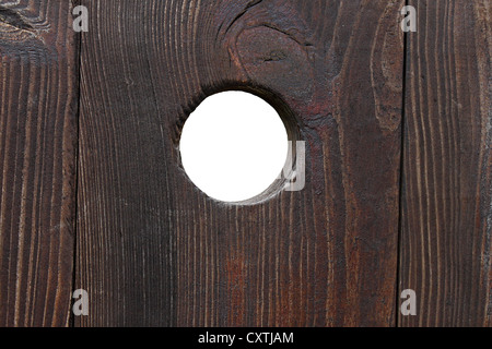 peephole in a wooden door over white Stock Photo