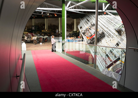 dh British National Motor museum BEAULIEU MUSEUMS HAMPSHIRE ENGLAND Woman looking at racing cars vistor uk visitors display Stock Photo