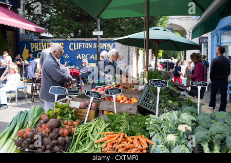 dh Vegetable shop CLIFTON VILLAGE BRISTOL People buying fresh vegetables grocery stall in street uk shops fruit market Stock Photo