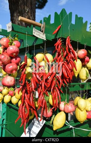 Dried peppers, lemons and pomegranates hanging on street stall, Sirmione, Lake Garda, Province of Brescia, Lombardy Region, Ital Stock Photo